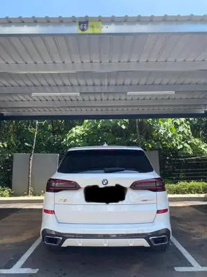 a white car parked in a parking lot at Ipoh The Cove Elegant Homestay Tambun in Ipoh