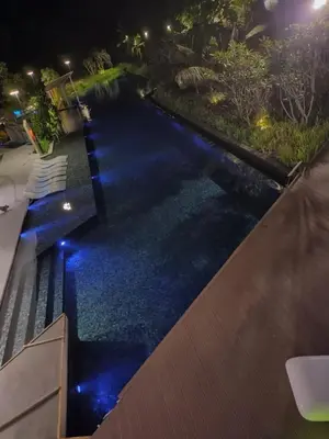 a pool with blue lights in a backyard at night at Ipoh The Cove Elegant Homestay Tambun in Ipoh