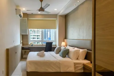 a bedroom with a large bed with a window at 2R2B/Cosy House/1~8pax/Gurney/Mansion One in George Town