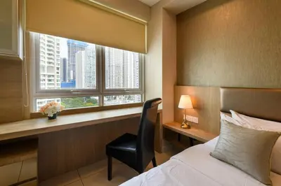 a bedroom with a bed and a chair and a window at 2R2B/Cosy House/1~8pax/Gurney/Mansion One in George Town