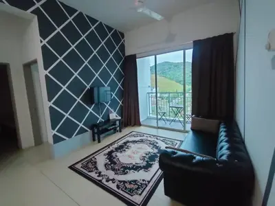 a living room with a leather couch and a large window at Golden Hills Pasar Malam 3 Bedroom Apartment J LouvRe in Tanah Rata