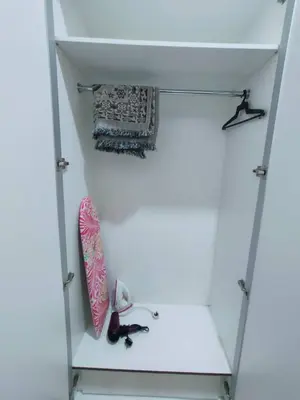 a white cabinet with a skateboard in it at Golden Hills Pasar Malam 3 Bedroom Apartment J LouvRe in Tanah Rata
