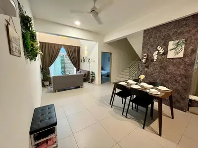a dining room and living room with a table and chairs at Aloft Cameron Highland in Brinchang