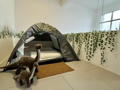 a bedroom with a tent and a cat on the floor at Aloft Cameron Highland in Brinchang