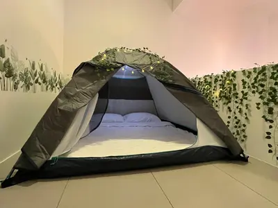 a bed in a tent in a room at Aloft Cameron Highland in Brinchang