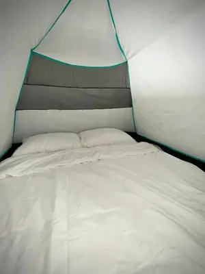 a large white bed in a tent at Aloft Cameron Highland in Brinchang