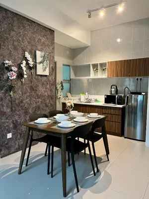a dining room with a table and chairs in a kitchen at Aloft Cameron Highland in Brinchang
