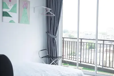 a bedroom with a bed and a large window at THE MAJESTIC IPOH A8 by ZamanJa in Ipoh