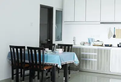 a kitchen with a table with a blue table cloth at THE MAJESTIC IPOH A8 by ZamanJa in Ipoh
