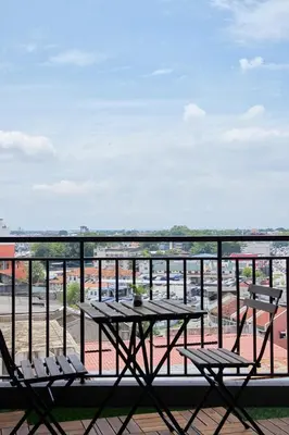 a table and chairs on a balcony with a view at THE MAJESTIC IPOH A8 by ZamanJa in Ipoh