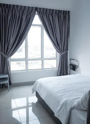 a bedroom with a bed and a large window at THE MAJESTIC IPOH A8 by ZamanJa in Ipoh