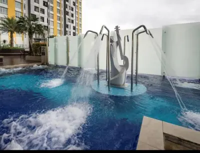 a water park with a water slide in a pool at THE MAJESTIC IPOH A8 by ZamanJa in Ipoh