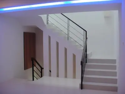 a staircase in a house with a blue light at Shamrock Beach Villas Batu Ferringhi Penang in Batu Ferringhi