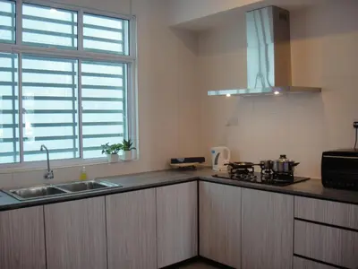 a kitchen with a sink and a counter top at Shamrock Beach Villas Batu Ferringhi Penang in Batu Ferringhi