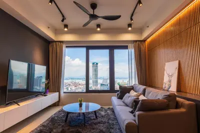 a living room with a couch and a large window at Executive Seaview 2Bedrooms Macalister Georgetown 4-6pax in George Town