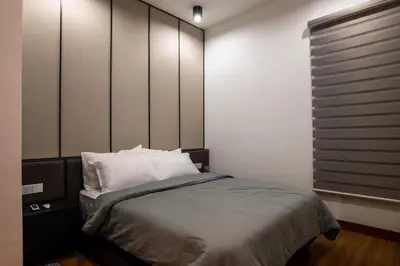 a bedroom with a large bed with white pillows at Executive Seaview 2Bedrooms Macalister Georgetown 4-6pax in George Town