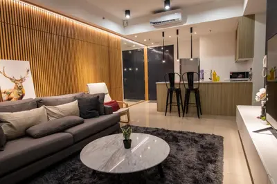 a living room with a couch and a table at Executive Seaview 2Bedrooms Macalister Georgetown 4-6pax in George Town