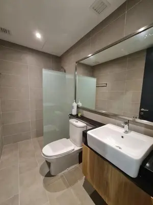 a bathroom with a toilet and a sink and a mirror at Executive Seaview 2Bedrooms Macalister Georgetown 4-6pax in George Town