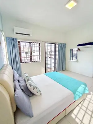 a bedroom with a large bed with blue pillows at Santorini 4 Bedrooms Full Air Cond Entire Home by Grab A Stay in Ipoh