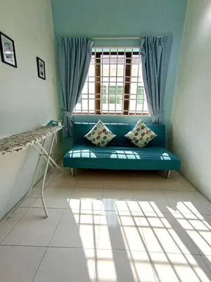 a blue couch in a room with a window at Santorini 4 Bedrooms Full Air Cond Entire Home by Grab A Stay in Ipoh