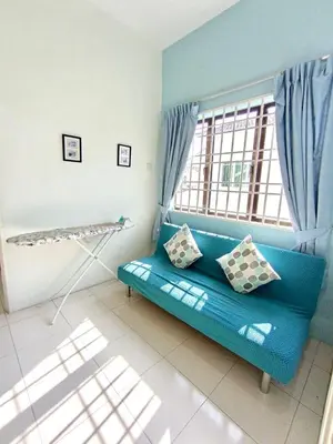 a blue couch in a room with a window at Santorini 4 Bedrooms Full Air Cond Entire Home by Grab A Stay in Ipoh