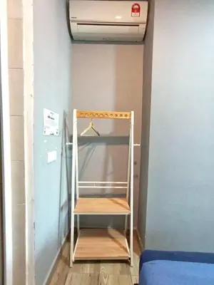 a shelf in the corner of a room at Octagon Premium Ipoh Town Center 2BR 101 by Grab A Stay in Ipoh