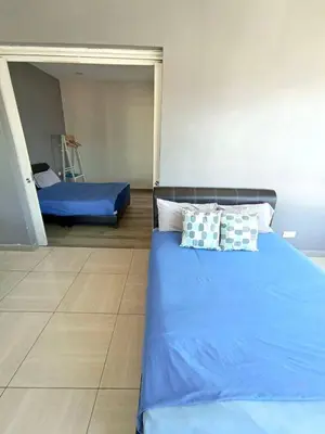 a bedroom with a bed with blue sheets and pillows at Octagon Premium Ipoh Town Center 2BR 121 by Grab A Stay in Ipoh