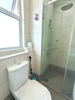 a bathroom with a toilet and a glass shower at Octagon Premium Ipoh Town Center 2BR 121 by Grab A Stay in Ipoh