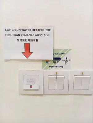 a sign that saysswitch on water heater here hydrogenginsarms air ddmm at Octagon Premium Ipoh Town Center 2BR 121 by Grab A Stay in Ipoh