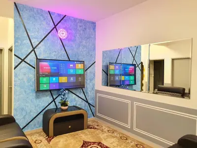 a living room with a tv and a mirror at HOMESTAY EPOH Meru Raya in Ipoh