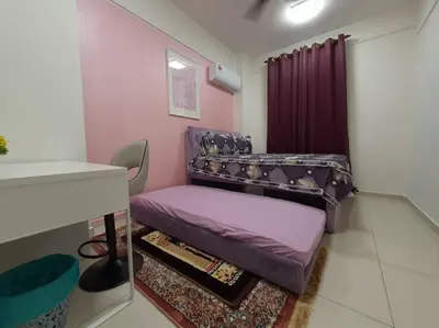 a small room with a purple bed and a table at HOMESTAY EPOH Meru Raya in Ipoh