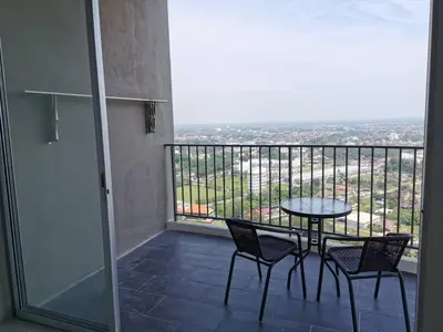 a balcony with a table and chairs and a view at Taiping Comfort Condo Homestay in Taiping