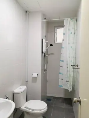 a white bathroom with a toilet and a shower at Taiping Comfort Condo Homestay in Taiping