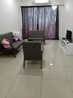 a living room with two couches and a teddy bear at Taiping Comfort Condo Homestay in Taiping