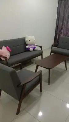 a stuffed animal sitting on a couch in a living room at Taiping Comfort Condo Homestay in Taiping
