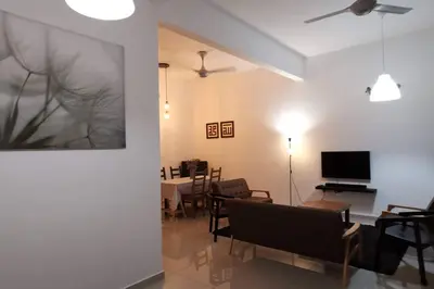 a living room with a couch and a dining room at The Dandelion Homestay in Baling