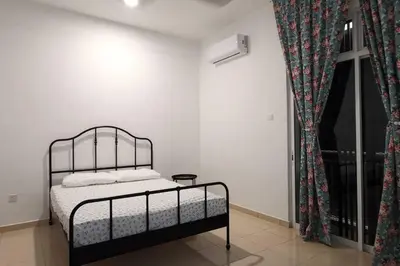 a bedroom with a bed and a window at The Dandelion Homestay in Baling