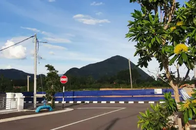 a stop sign on the side of a road at The Dandelion Homestay in Baling