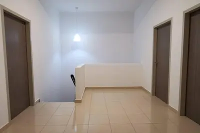 a hallway with two doors and a white wall at The Dandelion Homestay in Baling