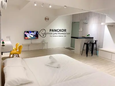 a bedroom with a large white bed and a television at Pangkor Better Life Cozy Studio-walking 2min to beach,1-4pax in Pangkor