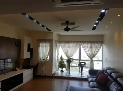 a living room with a couch and a ceiling fan at Best Sekinchan homestay in Sekincan