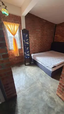a room with a bed and a window in a brick wall at Sayang Di Kaki Bukit Homestay Near Icon City Bukit Mertajam in Bukit Mertajam