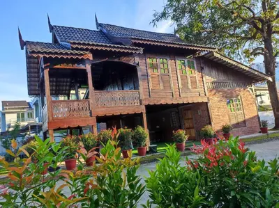 a house with wooden balconies and plants in front of it at Sayang Di Kaki Bukit Homestay Near Icon City Bukit Mertajam in Bukit Mertajam