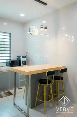 a kitchen with a table and two stools at Ipoh MJ Boutique House by Verve (20pax) EECH79 in Ipoh