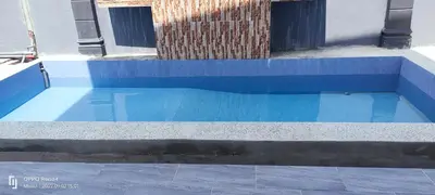 a blue swimming pool with blue tiles on the ground at Rania Homestay With Private Pool Seri Iskandar Perak Near UTP UITM in Kampong Bota Road