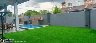 a backyard with a fence and a swimming pool at Rania Homestay With Private Pool Seri Iskandar Perak Near UTP UITM in Kampong Bota Road