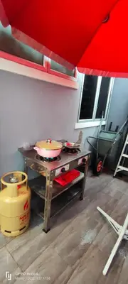 a room with a table and a red umbrella at Rania Homestay With Private Pool Seri Iskandar Perak Near UTP UITM in Kampong Bota Road