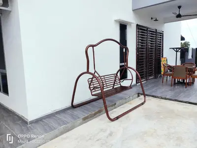 a metal bench sitting on the side of a house at Rania Homestay With Private Pool Seri Iskandar Perak Near UTP UITM in Kampong Bota Road