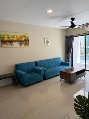 a living room with a blue couch and a table at KH Water Park Manhattan Condo Ipoh Homestay in Kampong Pinji