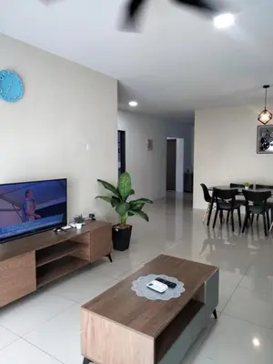 a living room with a television and a table at KH Water Park Manhattan Condo Ipoh Homestay in Kampong Pinji